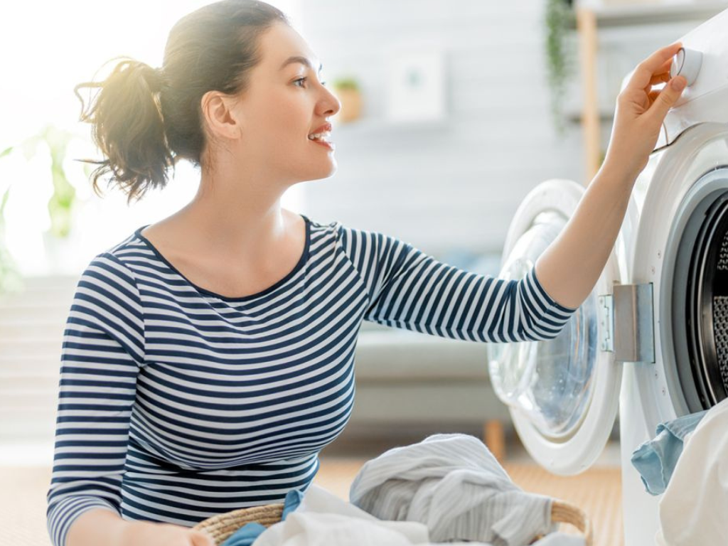 A resident setting the washing machine’s cycle